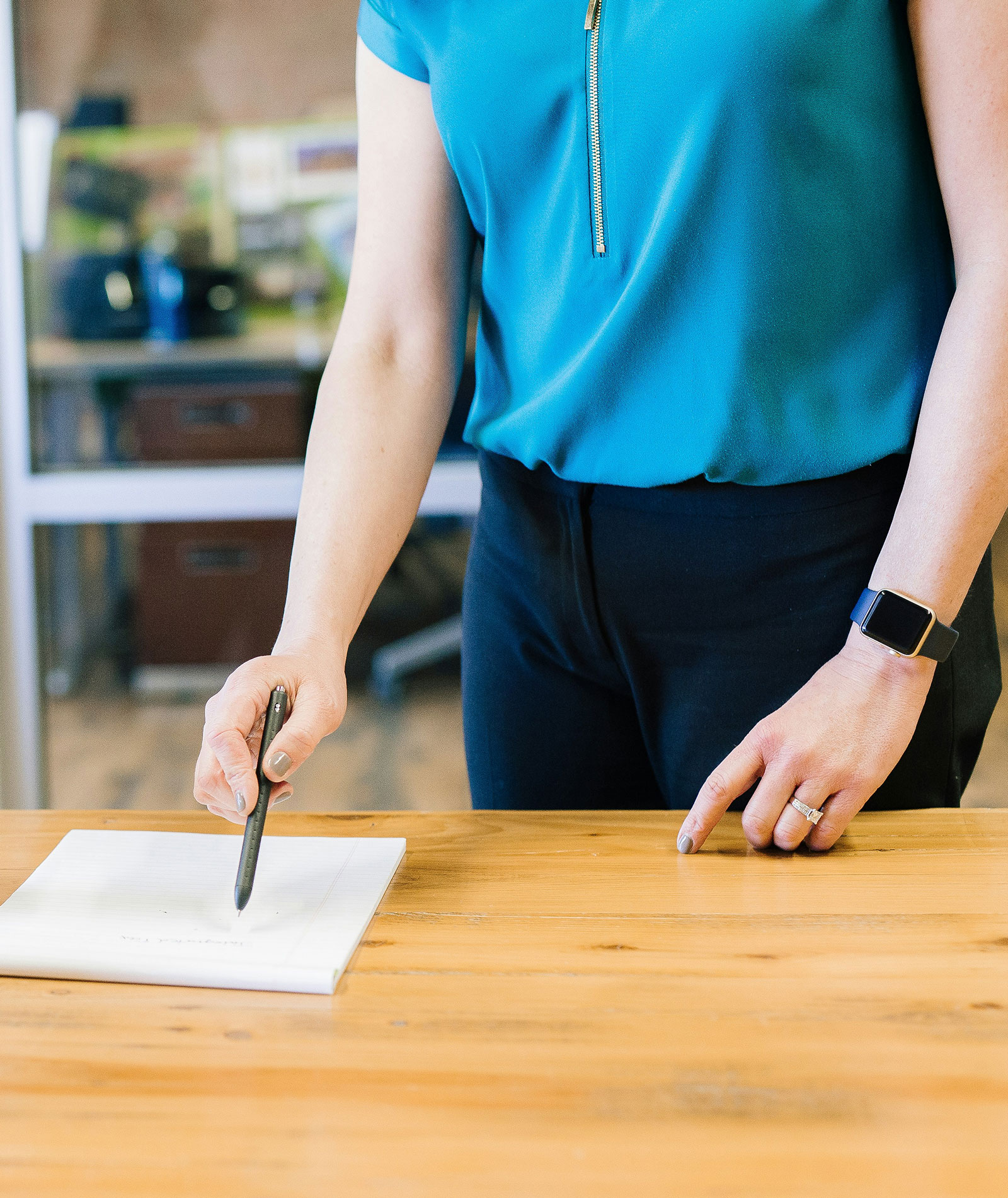 person-pointing-at-paper-on-table